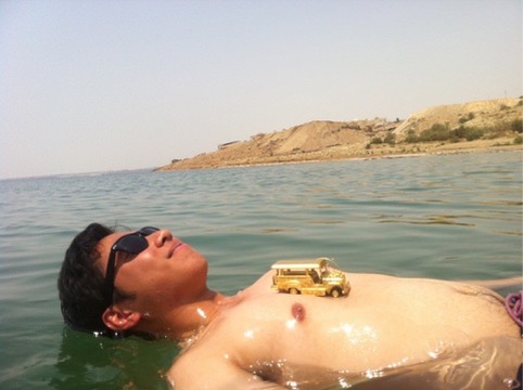 Traveler floating with a golden jeepney on his chest