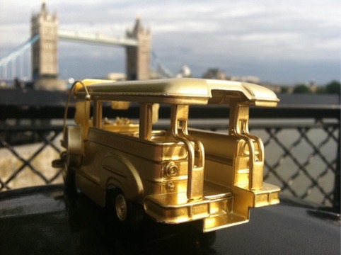 Golden jeepney overlooking Tower Bridge