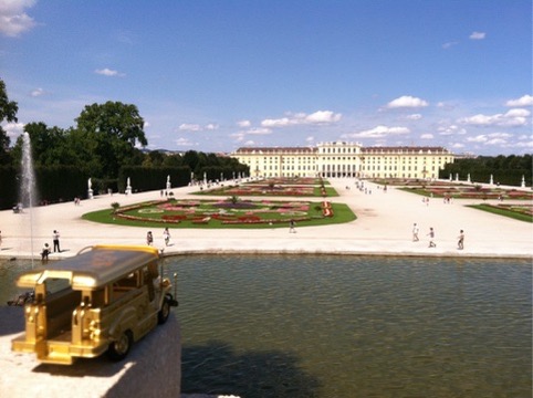 Golden jeepney overlooking Schönbrunn Palace and gardens